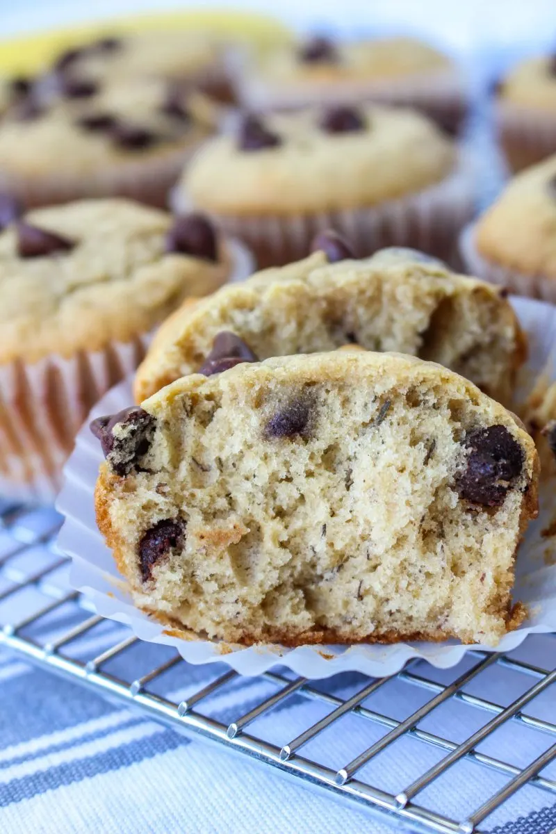 A Peanut Butter Banana Muffin torn in half showing a soft fluffy crumb - Hostess At Heart