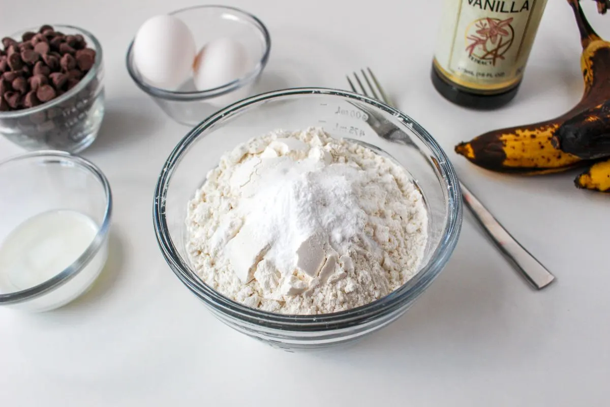 Flour, salt, and baking soda in a mixing bowl for Peanut Butter Bananna Muffins- Hostess At Heart