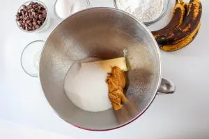 A mixing bowl containing butter, sugar, and peanut butter - Hostess At Heart