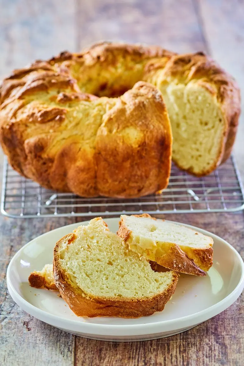 Bread shaped and baked in a bundt pan next to slices of the bread - Hostess At Heart