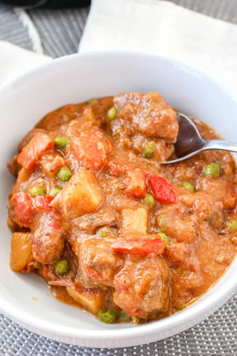 Top down view of a bowl of beef Caldereta stew - Hostess At Heart