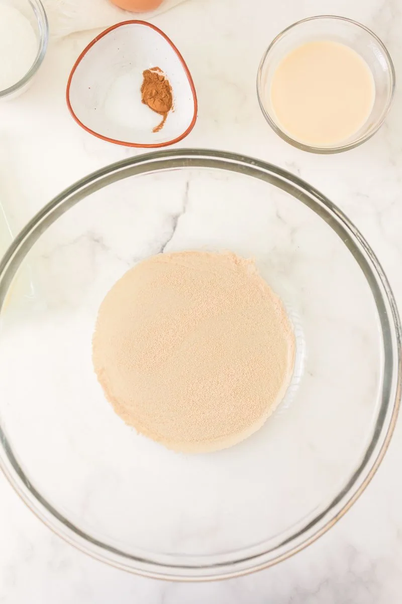 Sugar, water, and yeast in a glass bowl intended to bloom yeast - Hostess At Heart