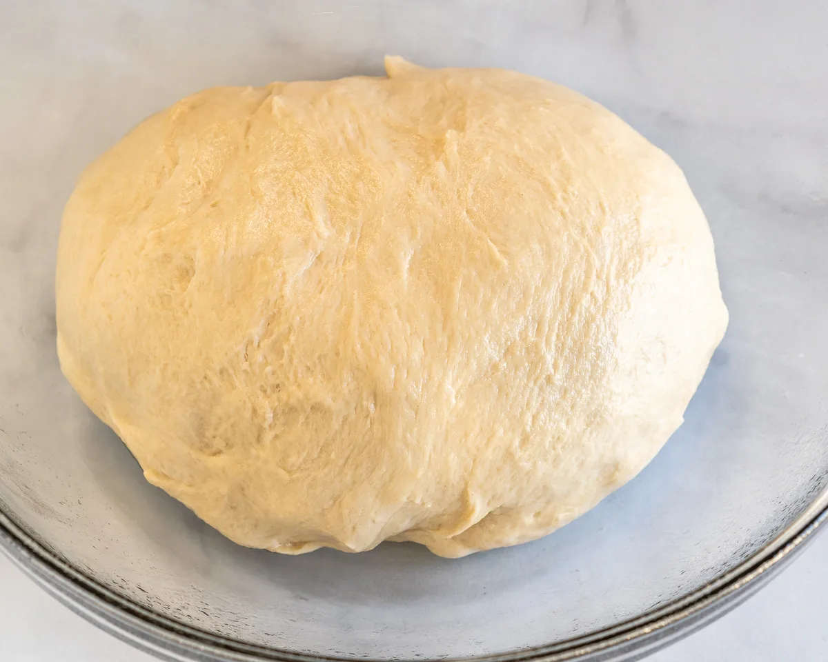 A ball of dough sitting in a greased bowl - Hostess At Heart