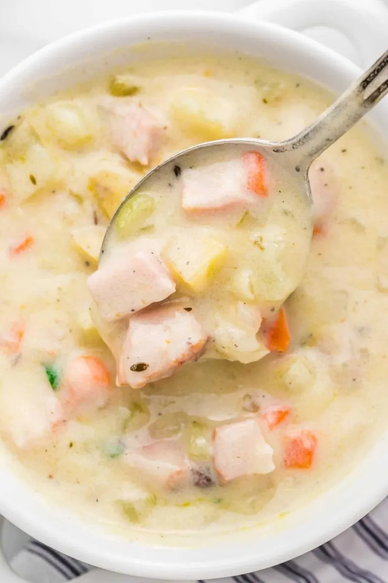 Top down view of a bowl of ham and potato soup