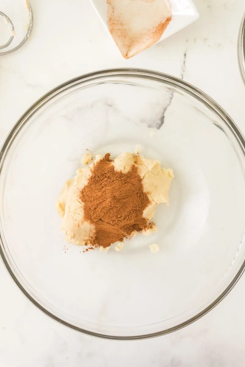 Cinnamon added to Concha topping dough in a glass bowl - Hostess At Heart