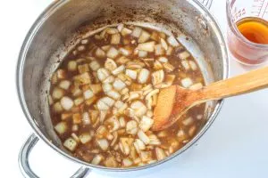 a saucepan filled with cooked onion and the liquid used to make Korean Beef Stew - Hostess At Heart