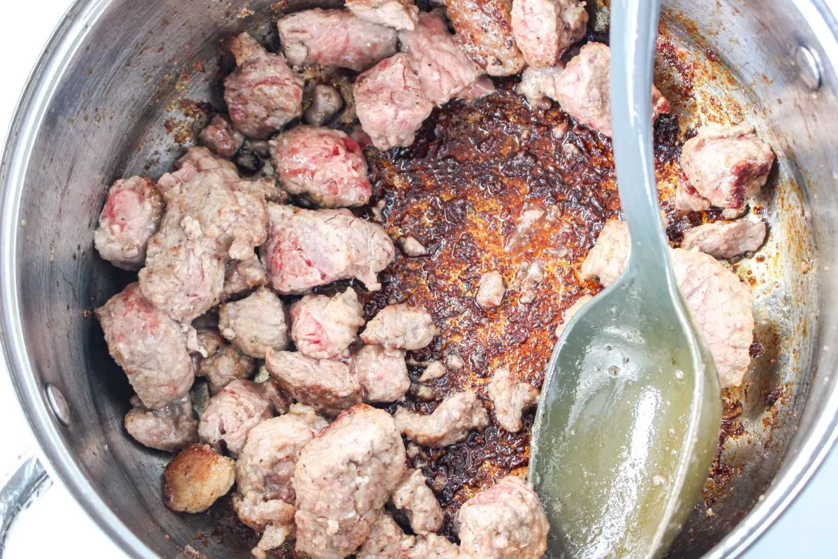 Top-down view of beef seared in a skillet. - Hostess At Heart