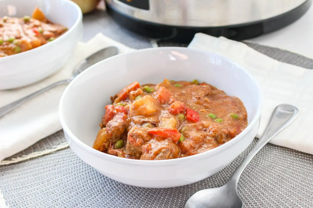 Angled view of a Korean beef stew filled with beef and vegetables in a tomato sauce. Hostess At Heart