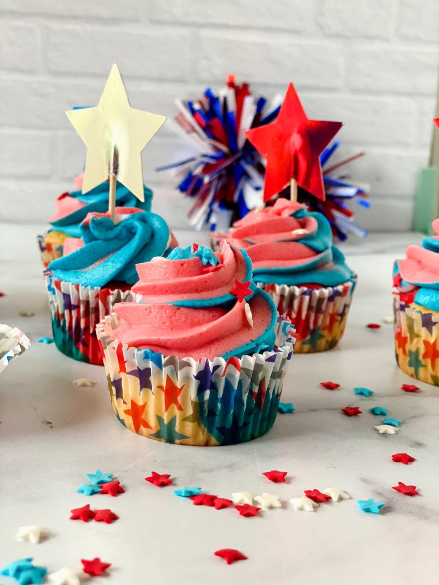 Sideview of red, white, and blue frosted cupcakes with 4th of July decorations - Hostess At Heart