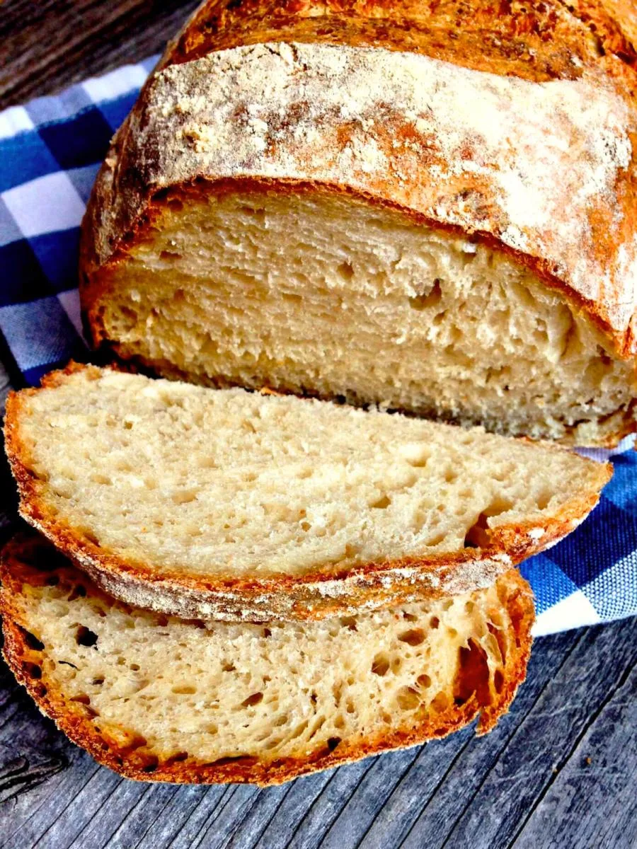 Front view of a loaf of sliced no-knead bread - hostess at heart