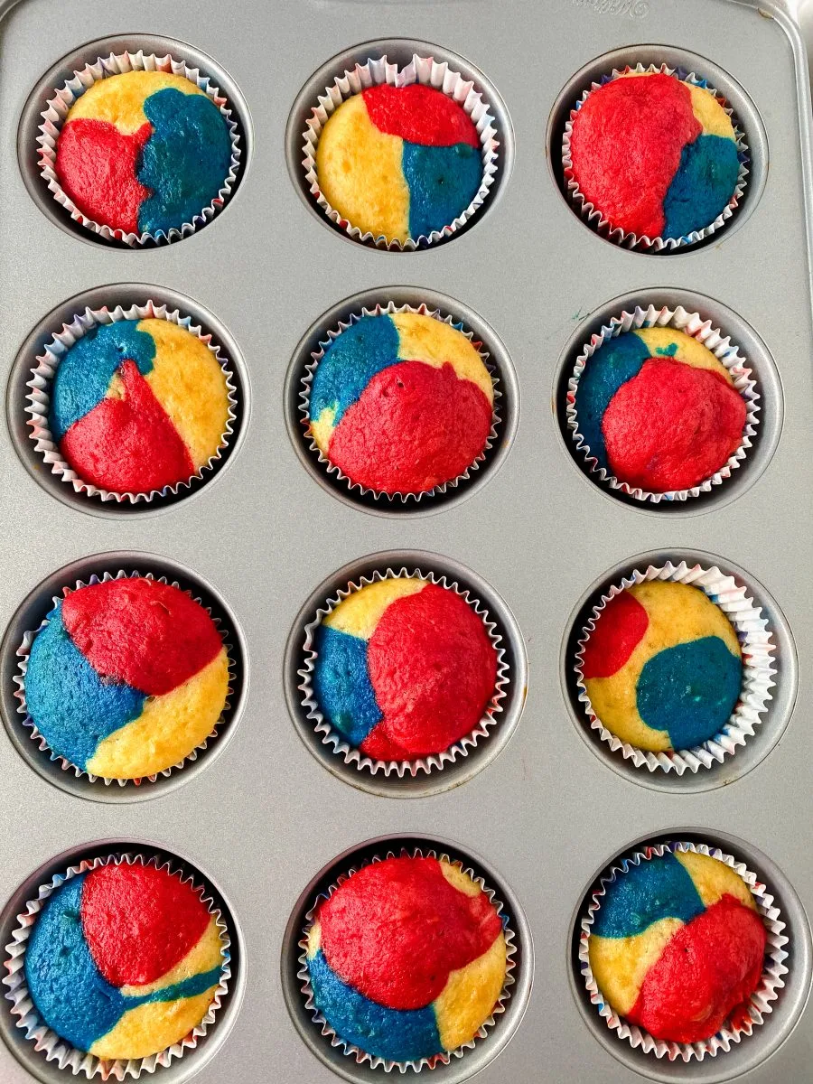 Top-down view of baked red, white, and blue cupcakes in a cupcake pan - Hostess At Heart