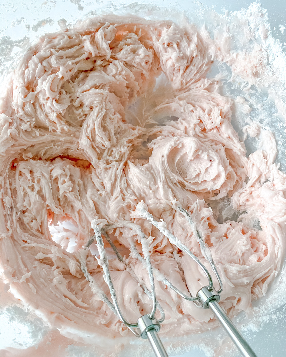 Top down view of a bowl of beaten strawberry cupcake batter.