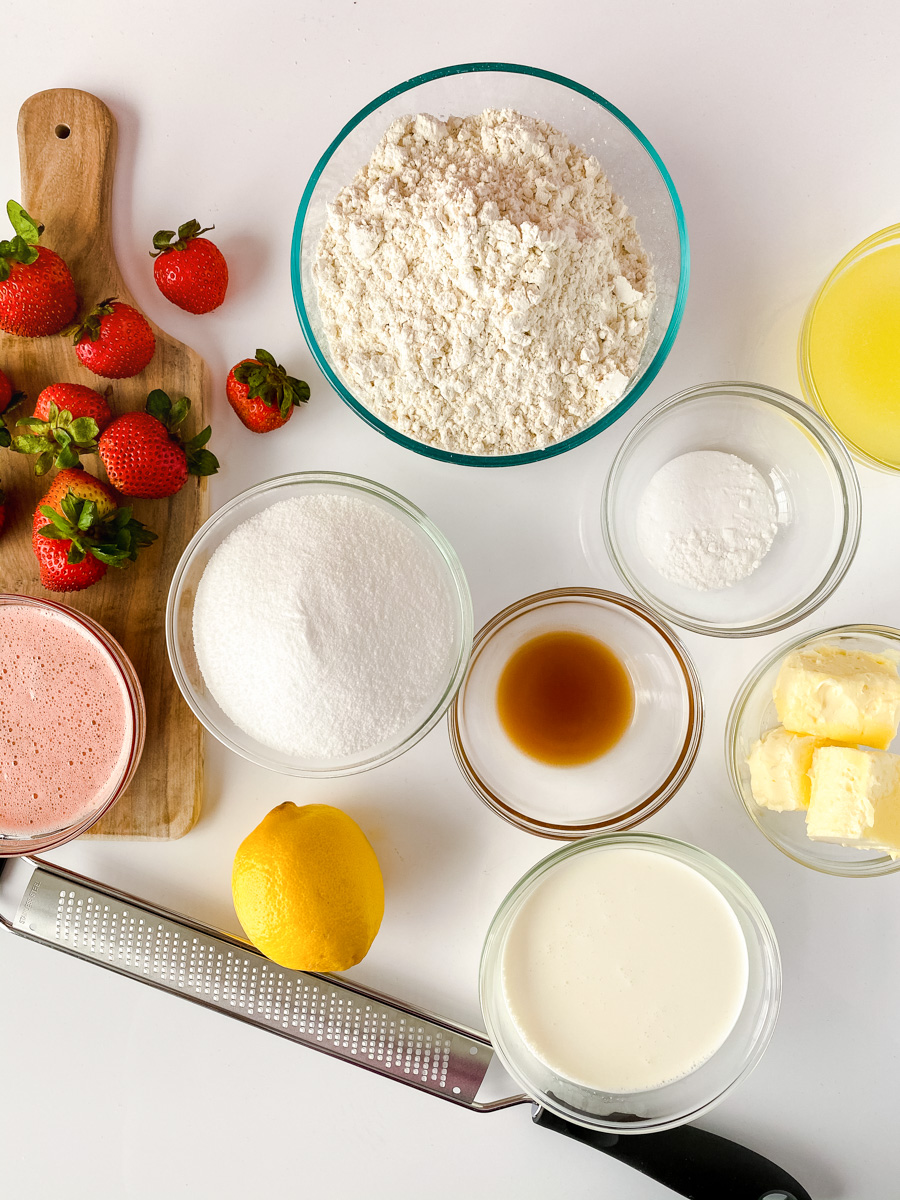 Ingredients used to make homemade strawberry cupcakes including strawberry puree, butter, lemon, milk, vanilla, salt, sugar, flour, egg whites, baking powder and baking soda - hostess at heart