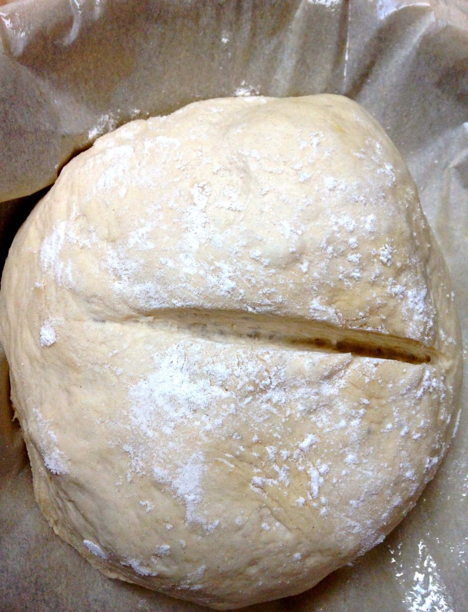 Bread dough with a score sliced down the middle - Hostess At Heart