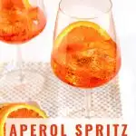 Front-view image for Pinterest of an Aperol Spritz cocktail with the title running across the bottom of the image. Hostess At Heart