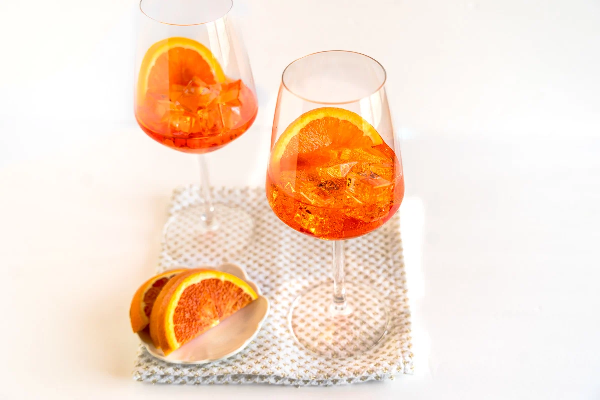 glass of orange aperol spritz cocktail isolated on white