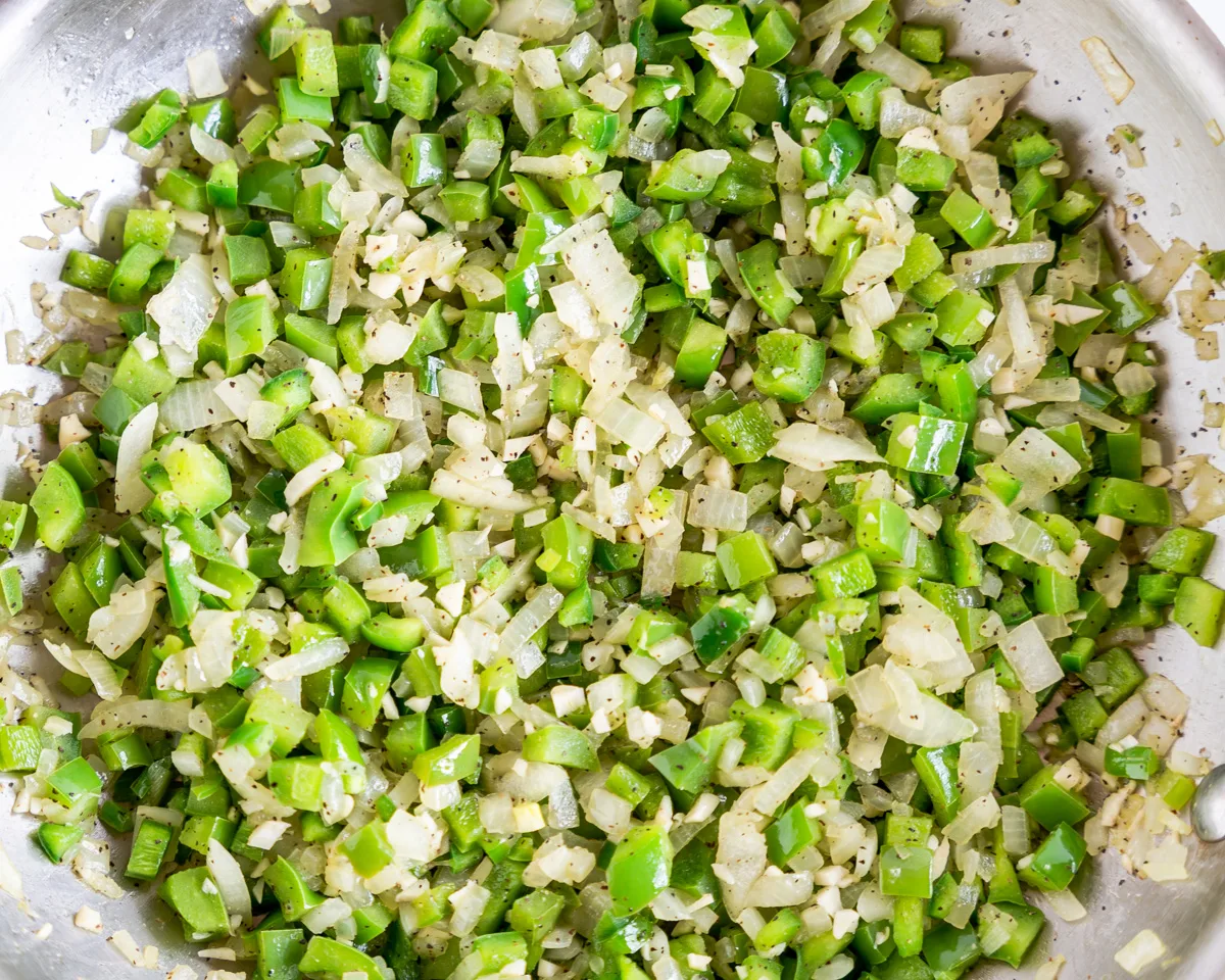 Diced Green Pepper, onion, and garlic, sauteing in a skillet. Hostess At Heart