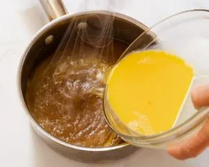 Beaten eggs being whipped into a hot sugar mixture - Hostess At Heart