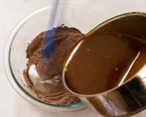 Melted chocolate mixture poured into dry ingredients - Hostess At Heart
