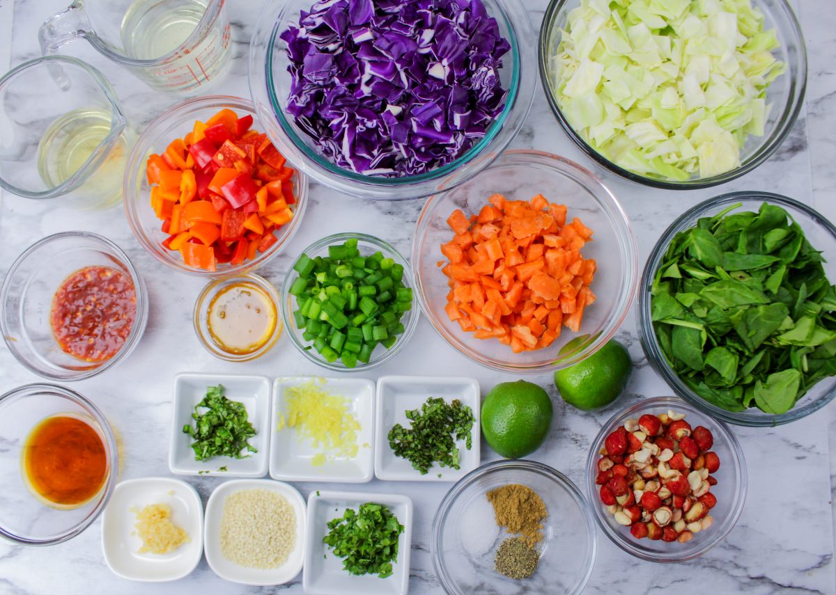 Top down view of small bowls holding the ingredients necessary to make a Chopped Thai Salad with Spicy Thai Dressing - Hostess At Heart