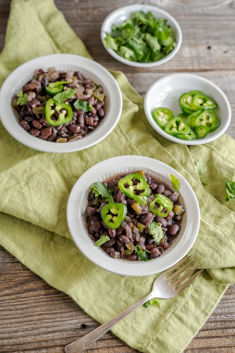 Angled view of cooked black beans in a bowl - Hostess At Heart