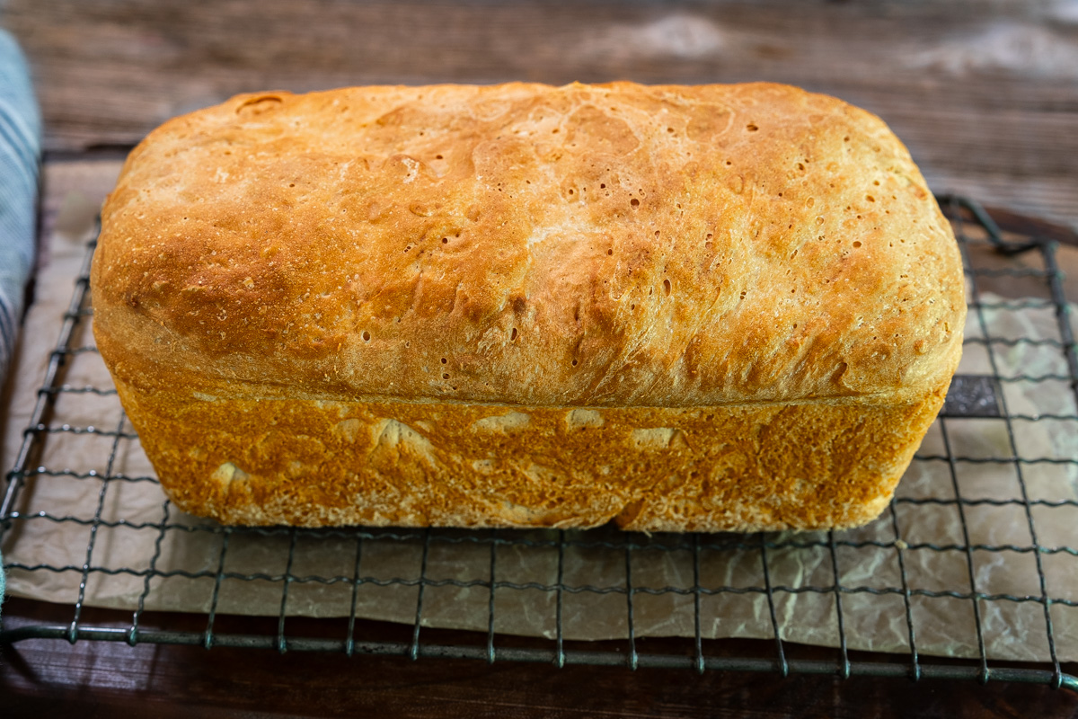 A side view of a beautifully baked golden brown loaf of English Muffin Toasting Bread - Hostess At Heart