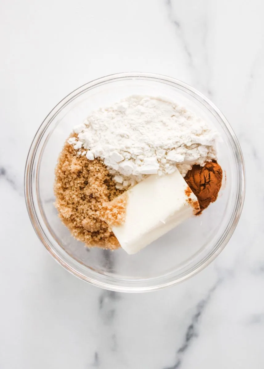 Streusel topping ingredients in a bowl including butter, cinnamon, brown sugar and flour.