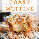 Frontview of a muffin with a bite taken out of it sitting on top of baked muffins in a muffin tin. Hostess At Heart