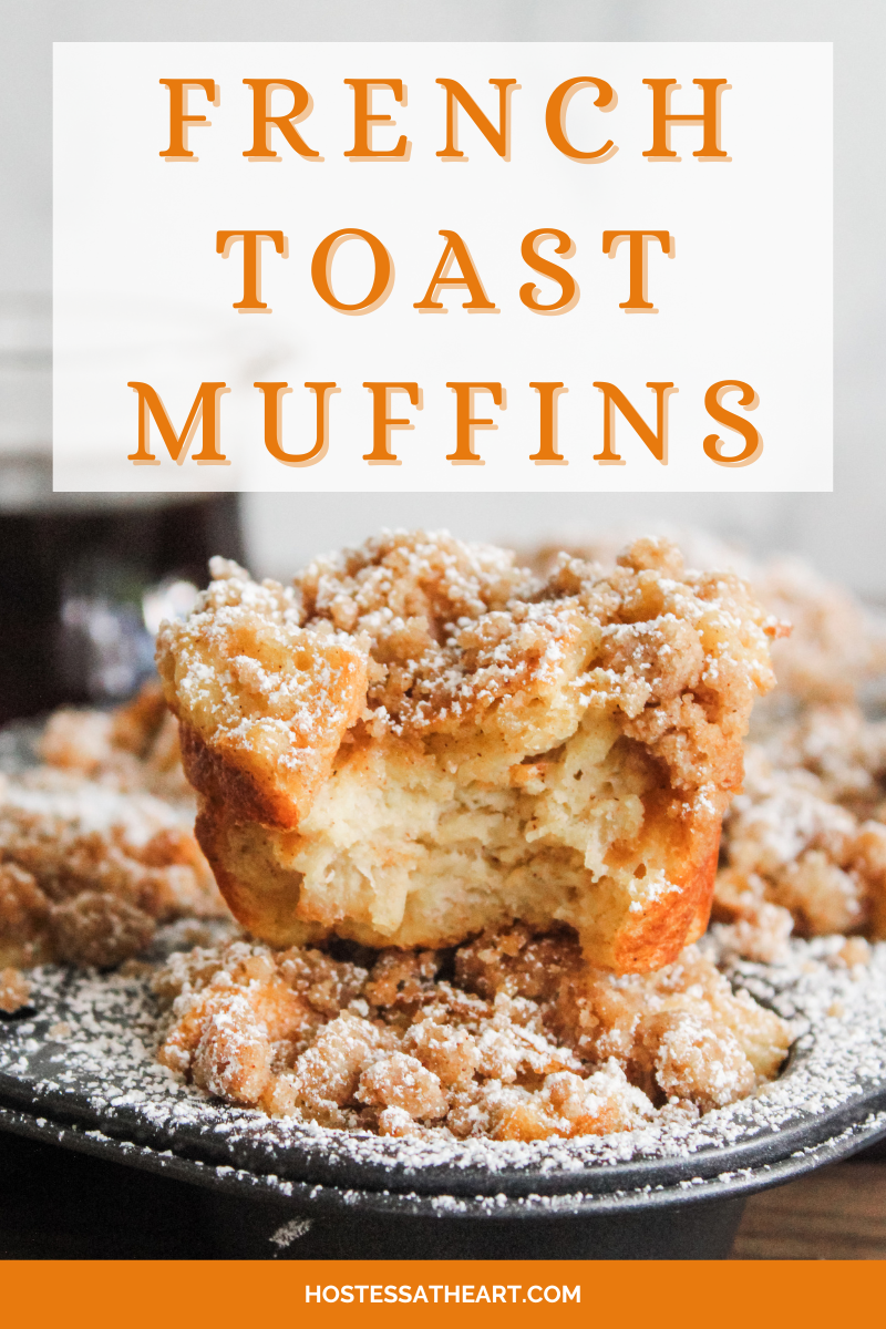 Frontview of a muffin with a bite taken out of it sitting on top of baked muffins in a muffin tin. Hostess At Heart
