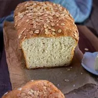 Front view of a loaf of bread with the end piece sliced off showing a soft tender crumb - Hostess At Heart