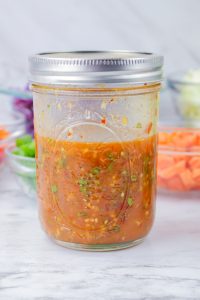 Side view of a jar filled with Spicy Thai Dressing - Hostess At Heart