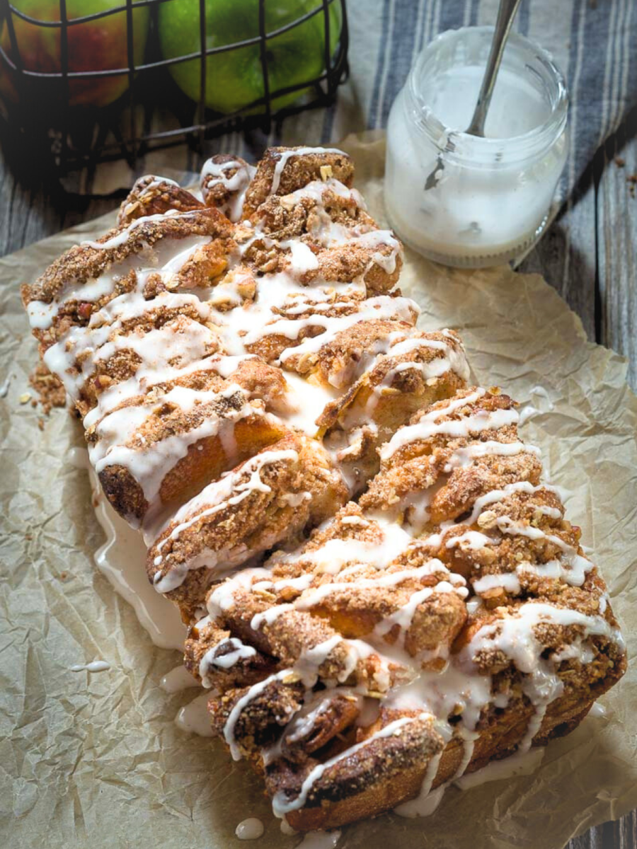 Top down view of a loaf of pull-apart bread topped with streusel and dripping sugar glaze - Hostess At Heart