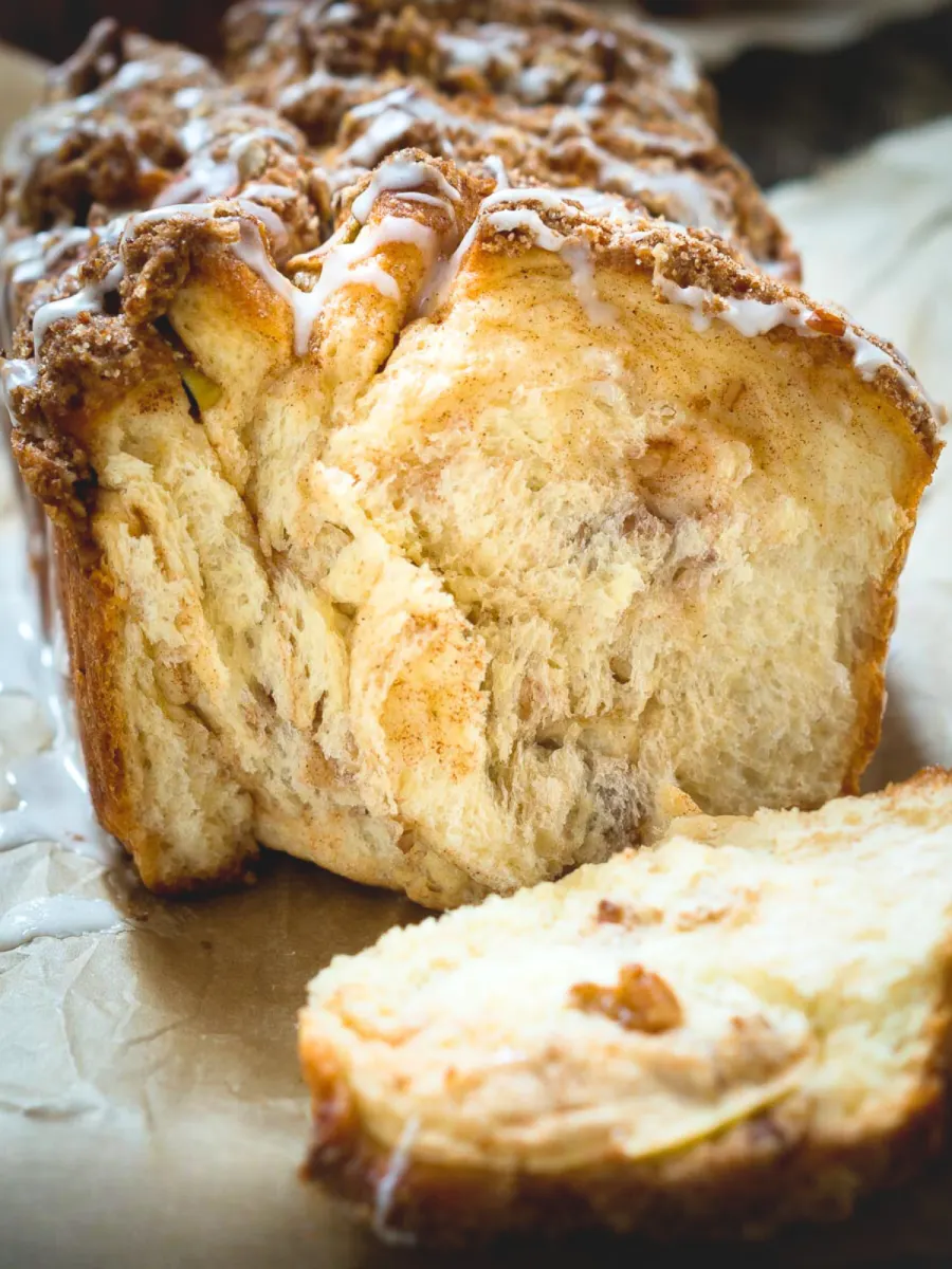 Front view of the front of a loaf of bread with the crust removed showing diced apple, ribbons of cinnamon and chopped pecans - Hostess At Heart