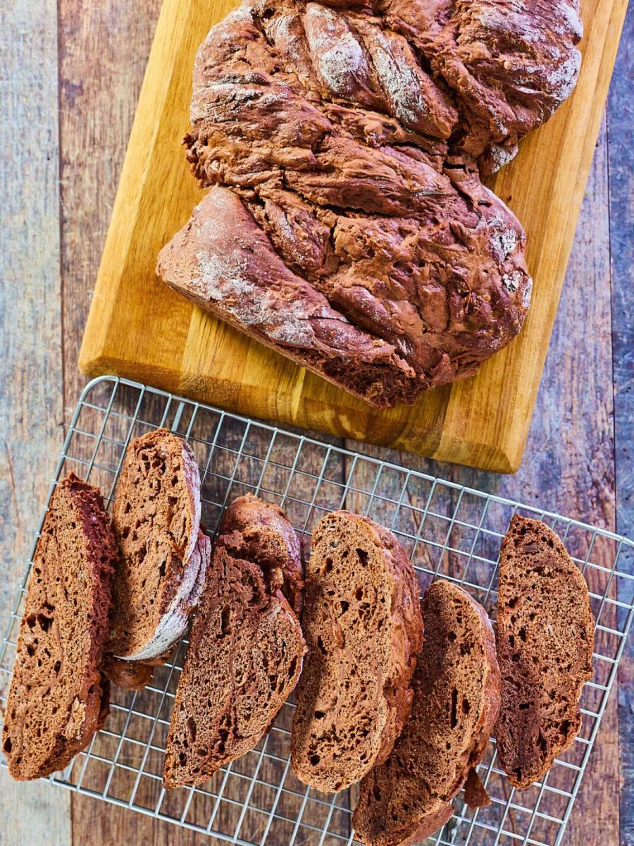 Top down view of a loaf of chocolate babka sliced on a cooling rack - Hostess At Heart