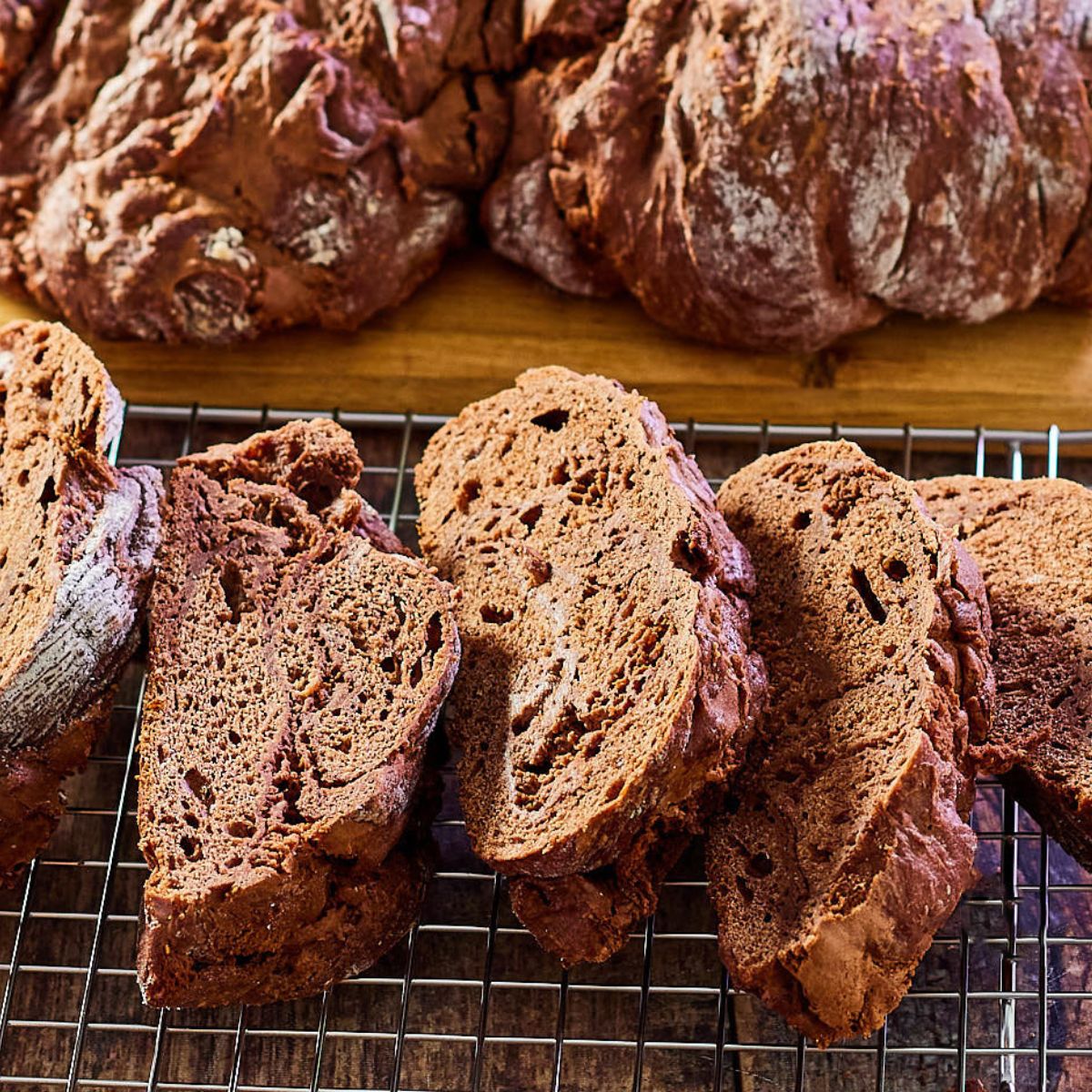 Angled view of slices of chocolate bread sitting on a cooling rack. Hostess At Heart