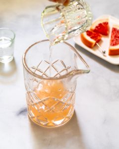 Vodka poured over Grapefruit Juice in a Cocktail Glass - Hostess At Heart