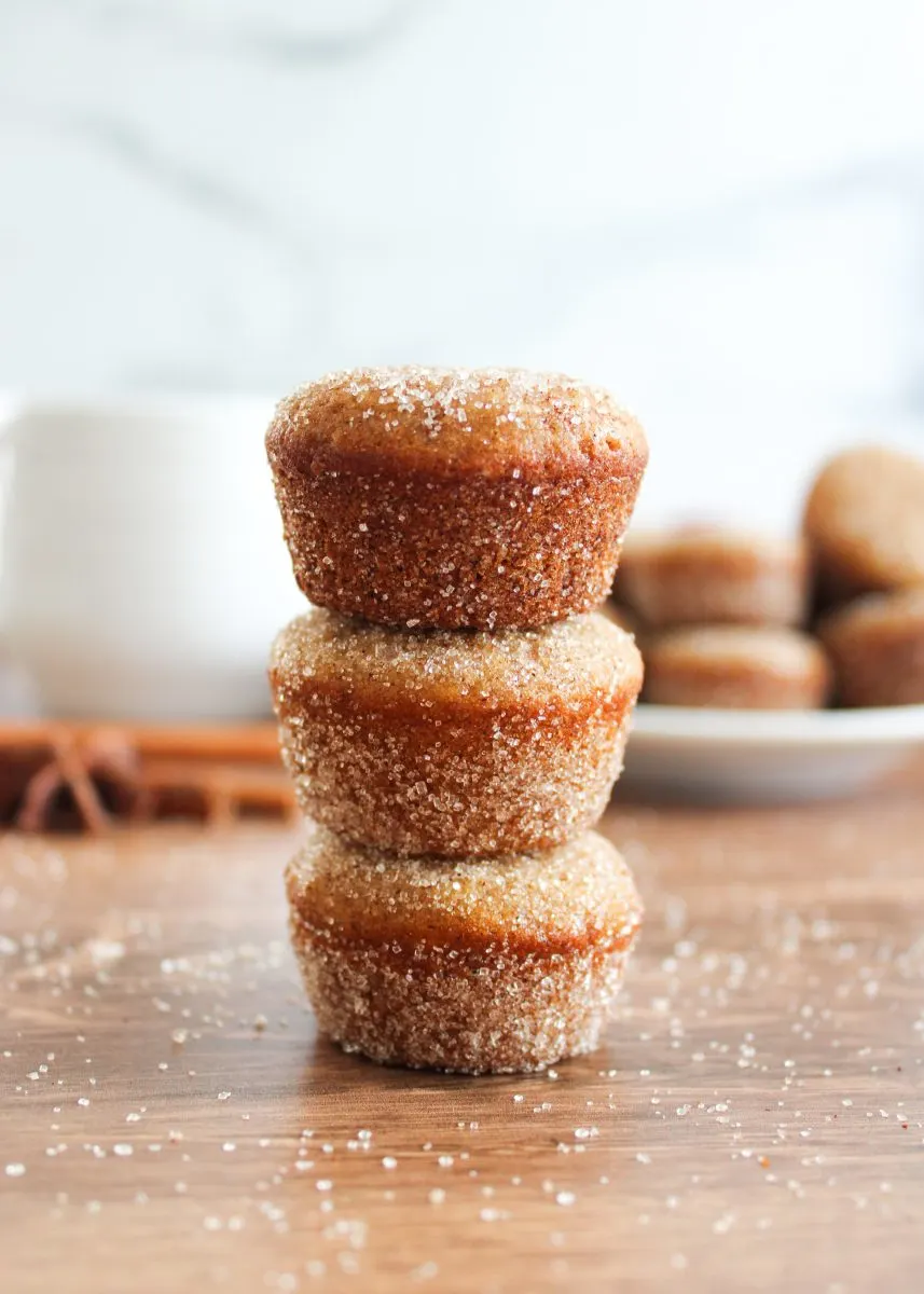 A stack of three cinnamon sugar coated mini homemade donut muffins. Hostess At Heart