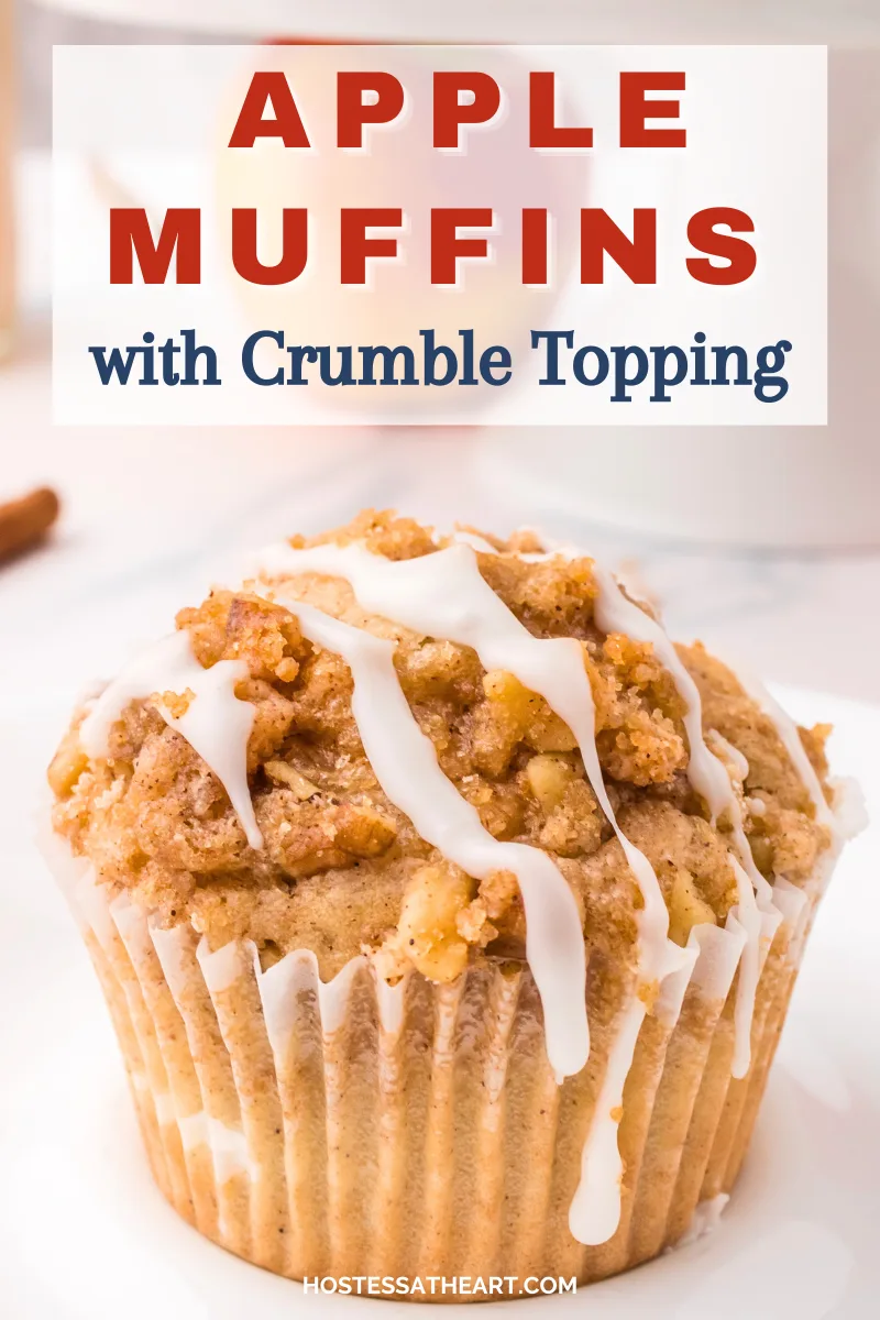 A table view of a baked Apple Crumble Muffin with glaze dripping off the side. Hostess At Heart