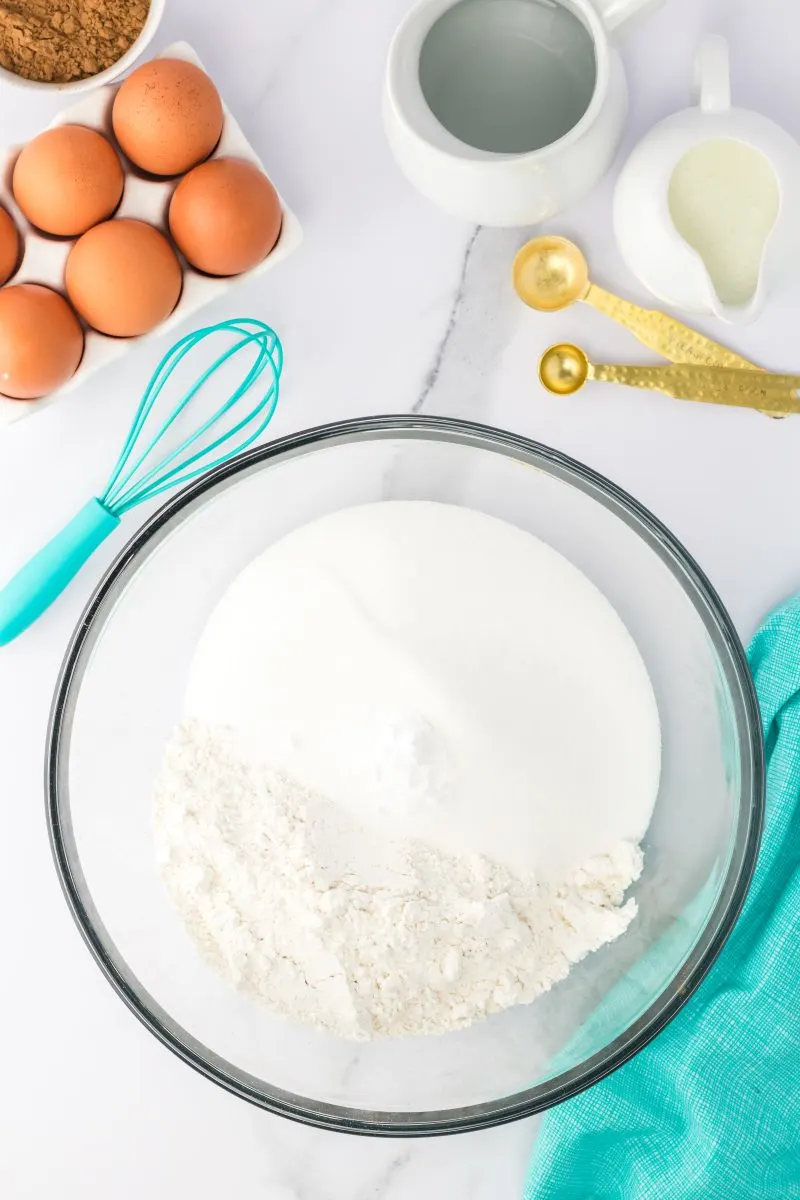 Mixing bowl filled with flour, sugar, salt, and baking soda. - Hostess At Heart