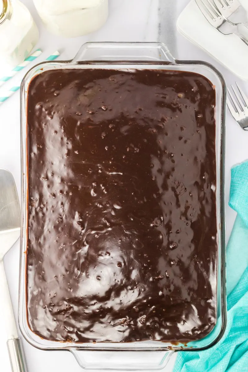 Top down view of a baking dish filled with chocolate buttermilk brownies topped in a smooth chocolate buttermilk icing - Hostess At Heart
