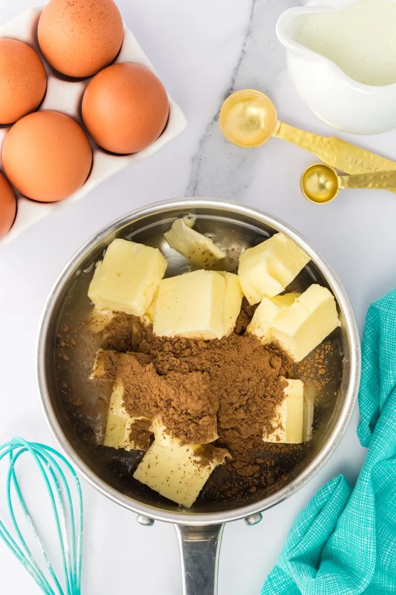 Saucepan filled with butter, cocoa, and water - Hostess At Heart