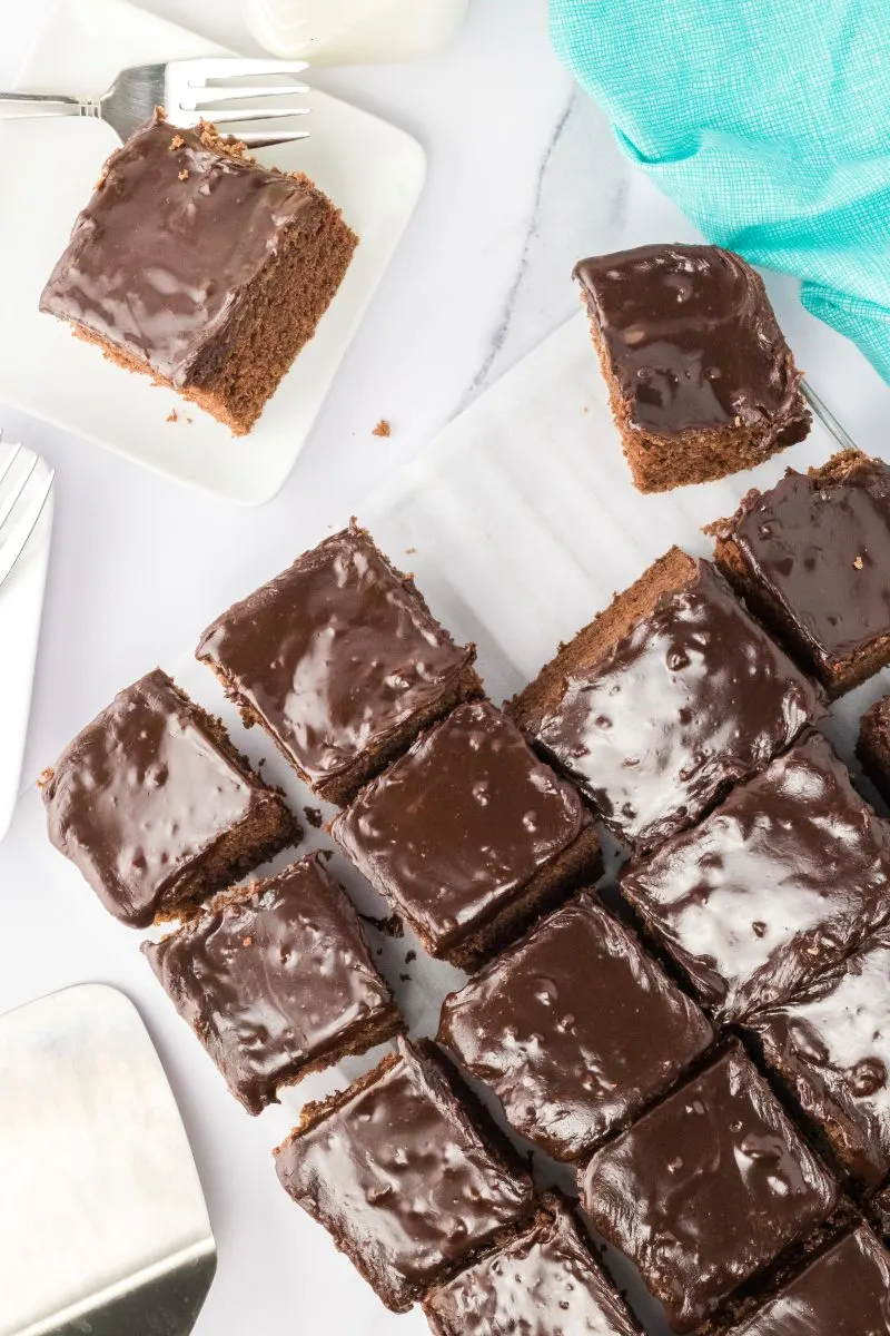 Top down view of cut pieces of buttermilk brownies topped with chocolate buttercream - Hostess At Heart