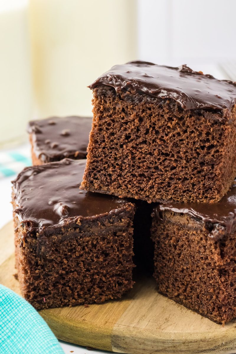 A pyramid of three brownies topped with chocolate frosting - Hostess At Heart