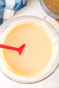 A bowl filled with properly mixed cream cheese batter - Hostess At Heart
