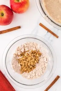 Chopped nuts added to crumbled topping in a bowl. Hostess At Heart