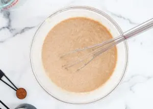 Top down view of a mixing bowl filled with batter. Hostess At Heart