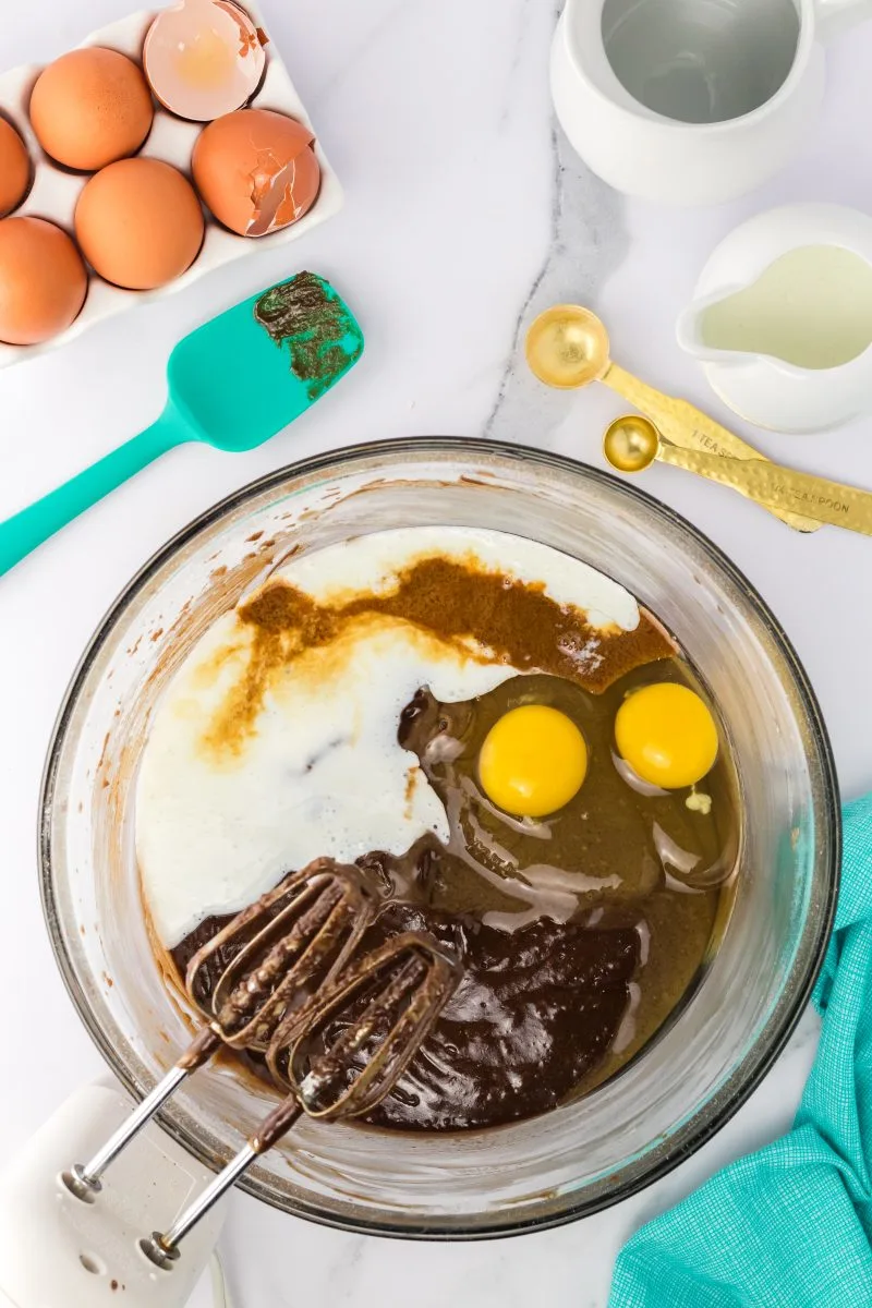 Mixing bowl with chocolate batter, eggs, cocoa, and buttermilk. Hostess At Heart