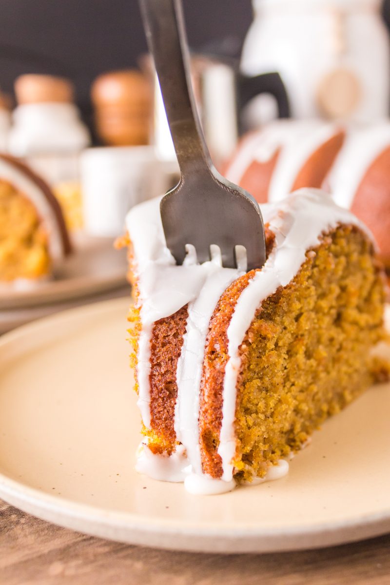 A fork inserted into a slice of glazed pumpkin bundt cake. Hostess At Heart