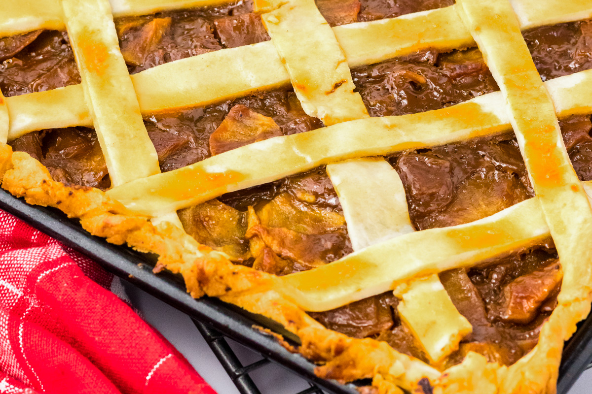 Angled partial view of a baked caramel apple slab pie with lattice crust - Hostess At Heart