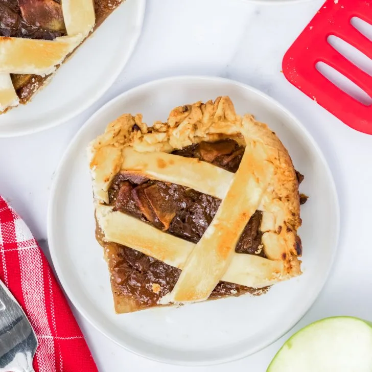 Top down view of a piece of caramel apple sheet pan pie sitting on a plate - Hostess At Heart